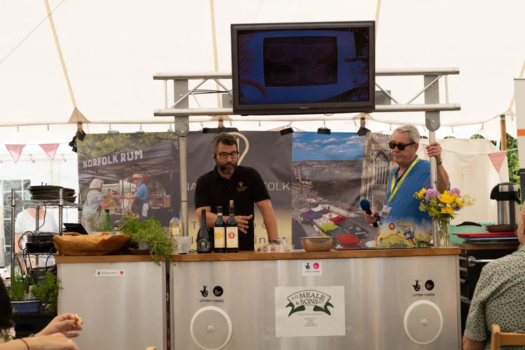 Marquee with the Native2Norfolk and festival logos on a big sign outside, advertising the cookery theatre