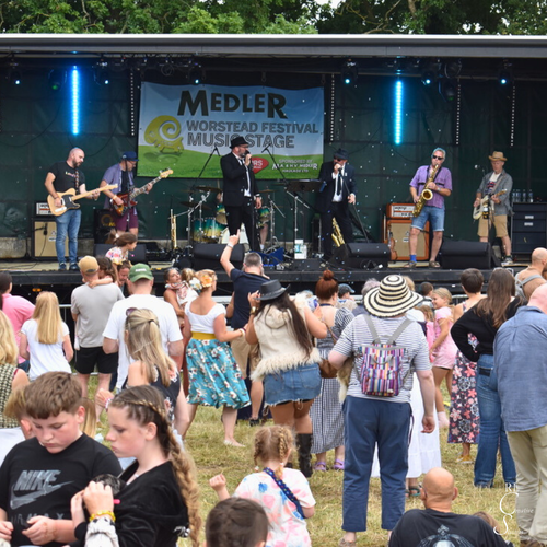 Musicians performing live on stage at a previous festival event